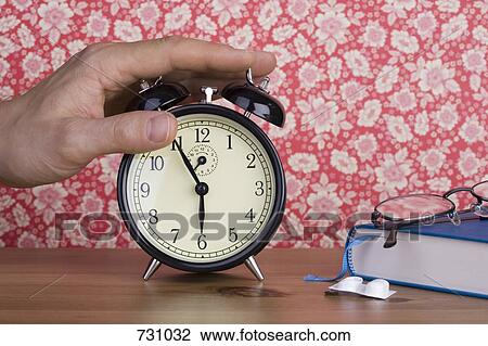 A human hand pressing an old-fashioned alarm clock View Large Photo Image Stock Image - A human hand pressing an old-fashioned alarm clock. Fotosearch