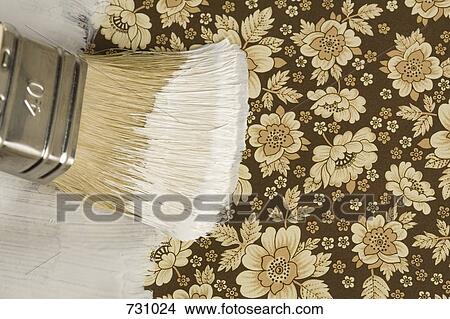 Picture - A paintbrush painting over wallpaper. Fotosearch