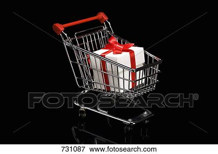 A shopping cart with a white box that has a ribbon wrapped around it View Large Photo Image Stock Photo - A shopping cart with a white box that has a ribbon wrapped around it. Fotosearch