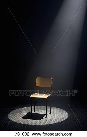 A spot lit empty chair View Large Photo Image Stock Image - A spot lit empty chair. Fotosearch