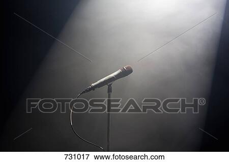 A spot lit microphone stand View Large Photo Image Stock Photo - A spot lit microphone stand. Fotosearch