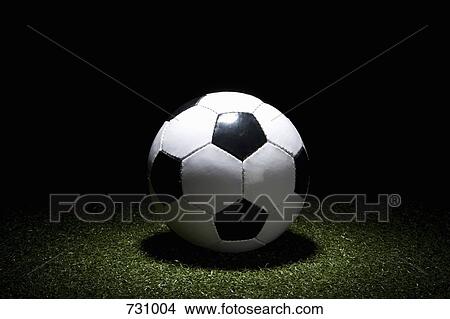A spot lit soccer ball on turf View Large Photo Image Picture - A spot lit soccer ball on turf. Fotosearch