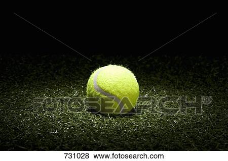 A spot lit tennis ball on turf View Large Photo Image Stock Photo - A spot lit tennis ball on turf. Fotosearch