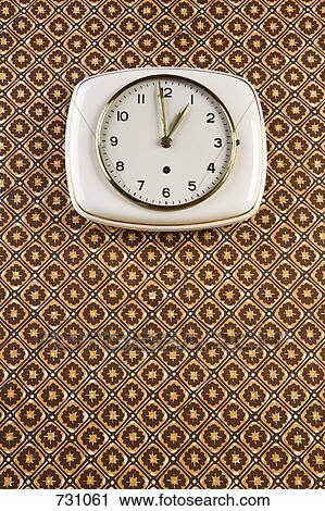 A wall clock hanging on patterned wallpaper View Large Photo Image Stock Image - A wall clock hanging on patterned wallpaper. Fotosearch