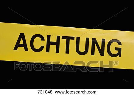 Stock Photo - Cordon tape with ACHTUNG on it. Fotosearch