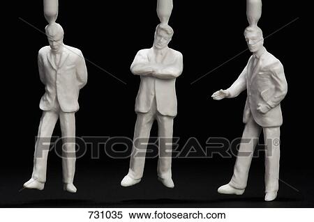Stock Photography - Three plastic businessmen figurines. Fotosearch