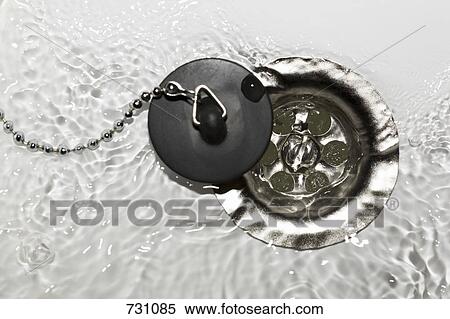 Stock Photography - Water running into a drain. Fotosearch