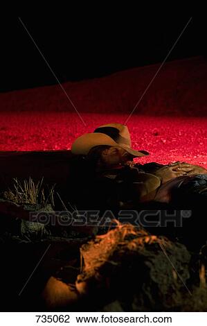 A cowboy illuminated by a campfire while sleeping View Large Photo Image Stock Image - A cowboy illuminated by a campfire while sleeping. Fotosearch