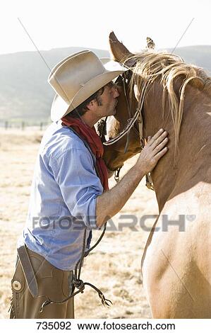 A cowboy kissing a horse View Large Photo Image Stock Image - A cowboy kissing a horse. Fotosearch