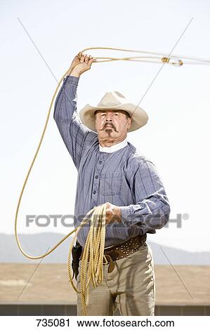 A cowboy lassoing View Large Photo Image Stock Image - A cowboy lassoing. Fotosearch