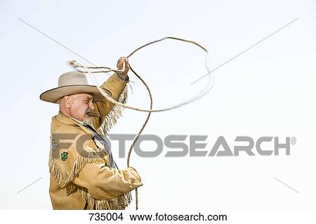 A cowboy throwing a lasso View Large Photo Image Picture - A cowboy throwing a lasso. Fotosearch