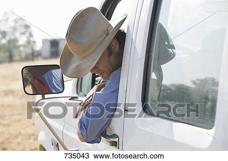 A man leaning out of his truck and looking down View Large Photo Image Stock Image - A man leaning out of his truck and looking down. Fotosearch