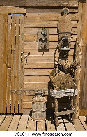 A wooden structure with a milk churn, lantern and chair View Large Photo Image Stock Photo - A wooden structure with a milk churn, lantern and chair. Fotosearch