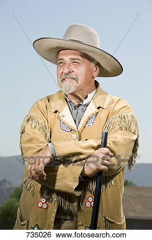 Portrait of a cowboy standing with his gun View Large Photo Image Stock Photograph - Portrait of a cowboy standing with his gun. Fotosearch