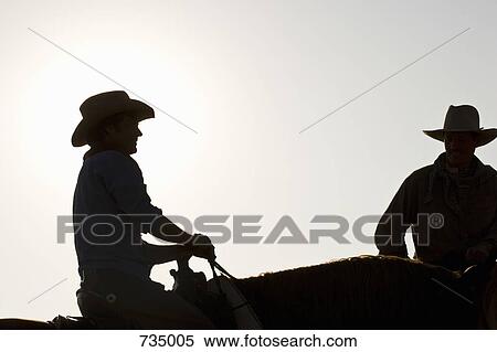 Silhouette of two cowboys sitting on horses View Large Photo Image Stock Photography - Silhouette of two cowboys sitting on horses. Fotosearch