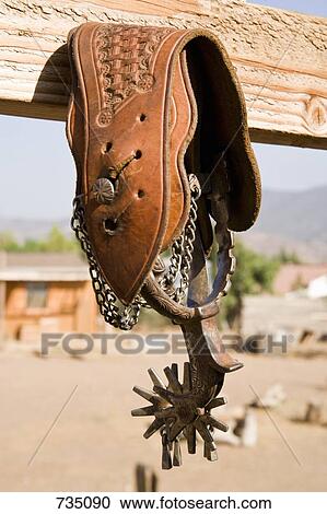Spurs hanging from a fence View Large Photo Image Stock Image - Spurs hanging from a fence. Fotosearch