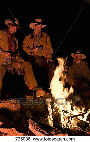 Three cowboys around a campfire View Large Photo Image Stock Photograph - Three cowboys around a campfire. Fotosearch
