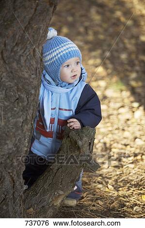 A baby boy leaning on a tree stump View Large Photo Image Stock Photograph - A baby boy leaning on a tree stump. Fotosearch