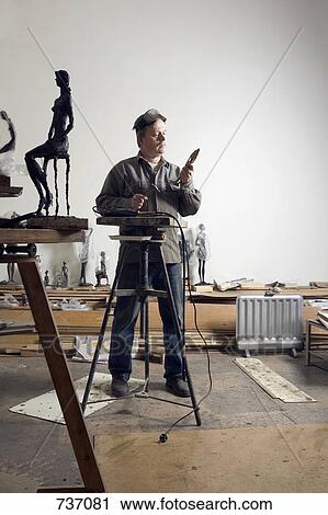 A sculptor working in an art studio View Large Photo Image Stock Image - A sculptor working in an art studio. Fotosearch