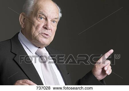 Stock Photo - A senior man talking, portrait. Fotosearch
