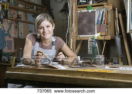 A young woman working in an art studio, portrait View Large Photo Image Stock Photography - A young woman working in an art studio, portrait. Fotosearch
