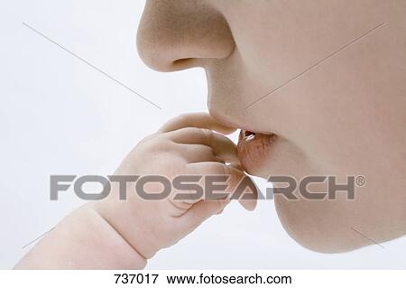 Human lips kissing an infant fingers View Large Photo Image Stock Photo - Human lips kissing an infant fingers. Fotosearch