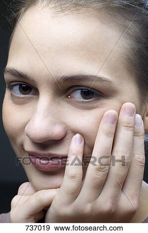 Portrait of a smiling young woman View Large Photo Image Stock Photo - Portrait of a smiling young woman. Fotosearch