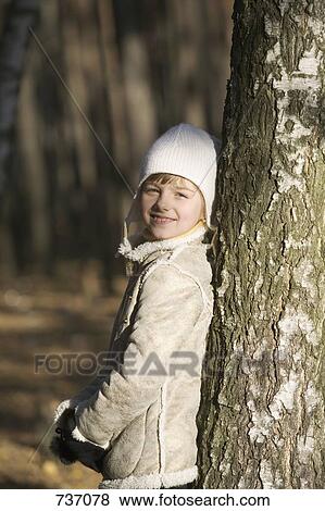 Stock Photo - Young girl leaning against. Fotosearch
