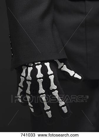 A person wearing a skeleton glove View Large Photo Image Stock Image - A person wearing a skeleton glove. Fotosearch