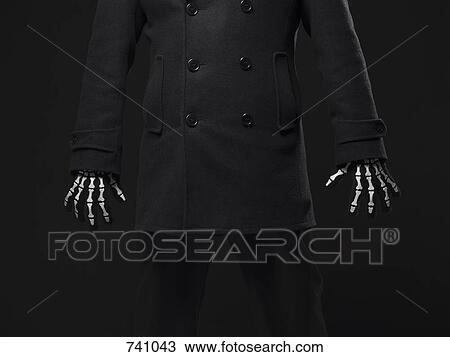 Stock Image - A person wearing skeleton gloves. Fotosearch