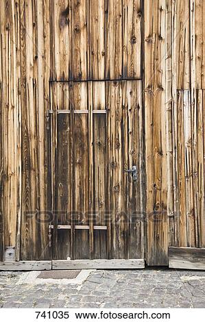 Stock Photography - A wooden door in a wooden building. Fotosearch