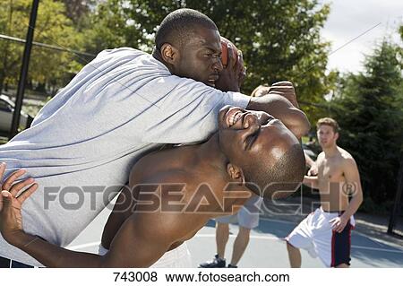 A basketball player fouling another player View Large Photo Image Stock Photo - A basketball player fouling another player. Fotosearch