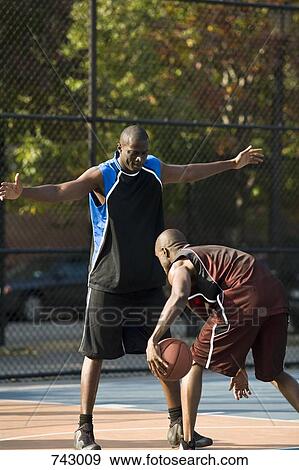A basketball player guarding another player View Large Photo Image Stock Photo - A basketball player guarding another player. Fotosearch