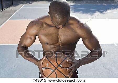 A basketball player holding a ball, portrait View Large Photo Image Stock Photography - A basketball player holding a ball, portrait. Fotosearch
