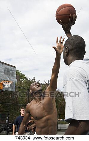 A basketball player preparing to make a shot View Large Photo Image Picture - A basketball player preparing to make a shot. Fotosearch