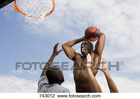 A basketball player preparing to make a slam dunk View Large Photo Image Stock Image - A basketball player preparing to make a slam dunk. Fotosearch
