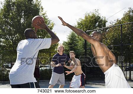 A basketball player preparing to make a shot View Large Photo Image Stock Image - A basketball player preparing to make a shot. Fotosearch