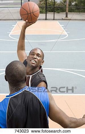 A basketball player preparing to make a shot View Large Photo Image Stock Image - A basketball player preparing to make a shot. Fotosearch
