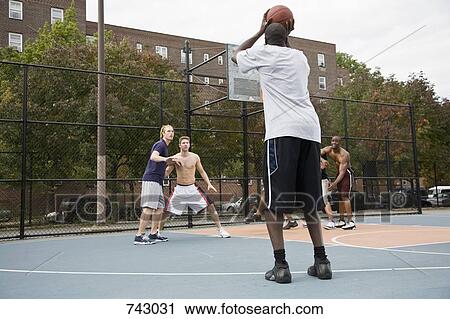 A basketball player preparing to make a shot View Large Photo Image Stock Image - A basketball player preparing to make a shot. Fotosearch