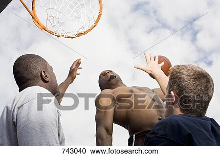 A basketball player preparing to make a slam dunk View Large Photo Image Stock Image - A basketball player preparing to make a slam dunk. Fotosearch