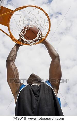 A basketball player preparing to make a slam dunk View Large Photo Image Stock Photograph - A basketball player preparing to make a slam dunk. Fotosearch