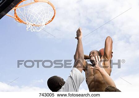 A basketball player preparing to make a slam dunk View Large Photo Image Stock Photography - A basketball player preparing to make a slam dunk. Fotosearch