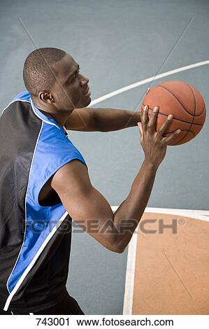 A man preparing to shoot a basketball View Large Photo Image Stock Image - A man preparing to shoot a basketball. Fotosearch