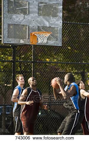 Four men playing basketball View Large Photo Image Stock Photograph - Four men playing basketball. Fotosearch