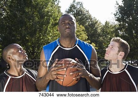 Three basketball players, in a row View Large Photo Image Picture - Three basketball players, in a row. Fotosearch