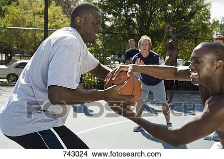 Two basketball players fighting over a basketball View Large Photo Image Picture - Two basketball players fighting over a basketball. Fotosearch