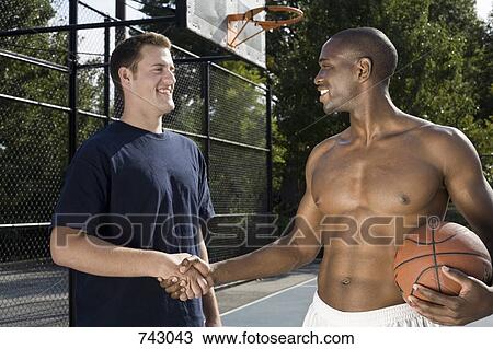 Stock Image - Two basketball players shaking hands. Fotosearch