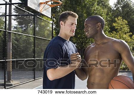 Stock Photo - Two basketball players shaking hands. Fotosearch