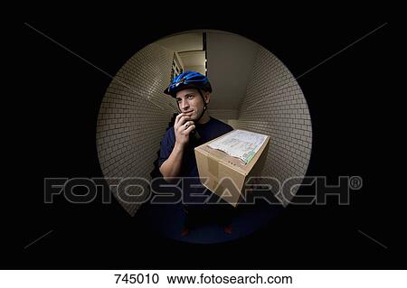 A bicycle messenger delivering a package View Large Photo Image Stock Image - A bicycle messenger delivering a package. Fotosearch