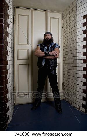 Stock Photograph - A bouncer standing in front of a door. Fotosearch